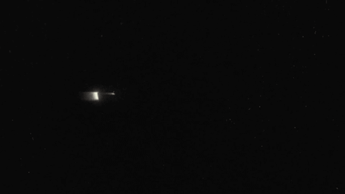 A Close Up Of A Batman Logo In The Dark . GIF