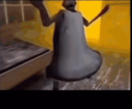 A Close Up Of A Bell With A Person Standing Behind It GIF