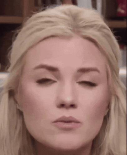 A Close Up Of A Blonde Woman Making A Funny Face GIF
