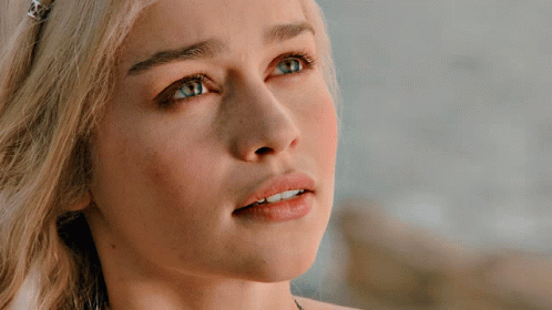 A Close Up Of A Blonde Woman 'S Face With Blue Eyes GIF