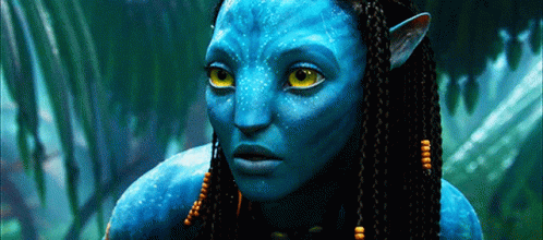 A Close Up Of A Blue Alien With Yellow Eyes GIF