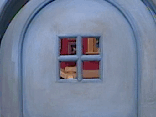 A Close Up Of A Blue Door With A Window In It GIF
