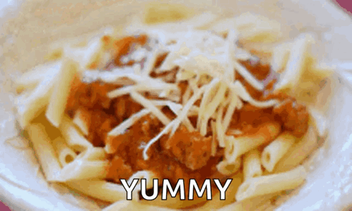 A Close Up Of A Bowl Of Pasta With The Word Yummy Written On It GIF