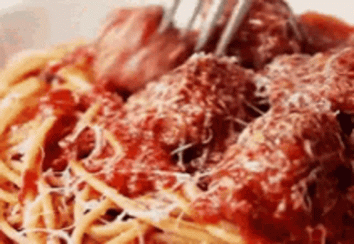A Close Up Of A Bowl Of Spaghetti And Meatballs With A Fork . GIF