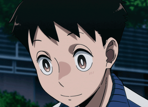 a close up of a boy 's face with a blue shirt