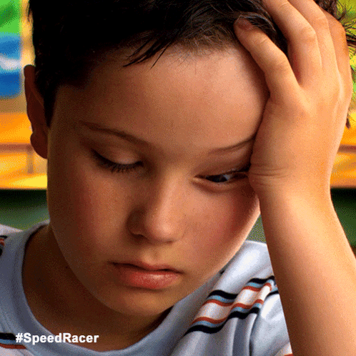 A Close Up Of A Boy 'S Face With The Hashtag #Speedracer On The Bottom GIF