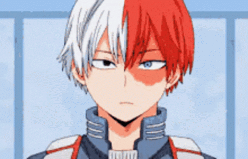 A Close Up Of A Boy With Red And White Hair And Blue Eyes . GIF