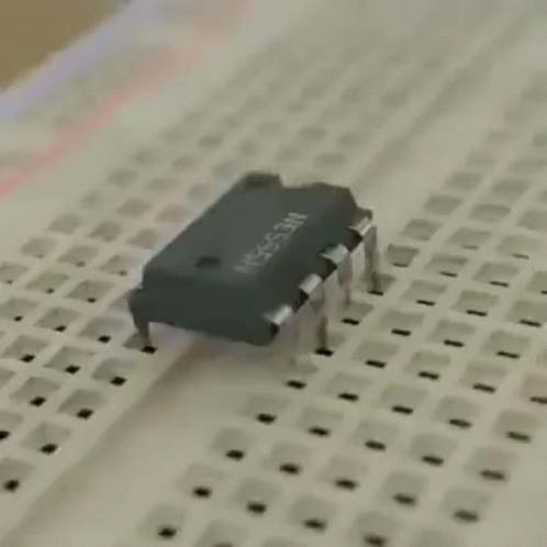 A Close Up Of A Breadboard With A Chip On It . GIF