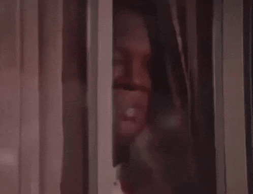A Close Up Of A Brown Curtain With A White Stripe GIF