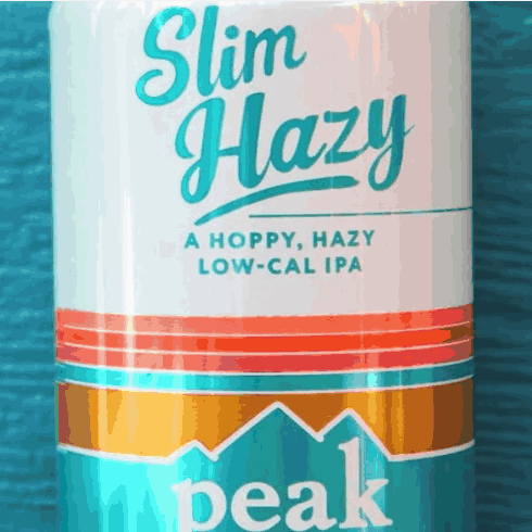 A Close Up Of A Can Of Slim Hazy Peak Beer GIF