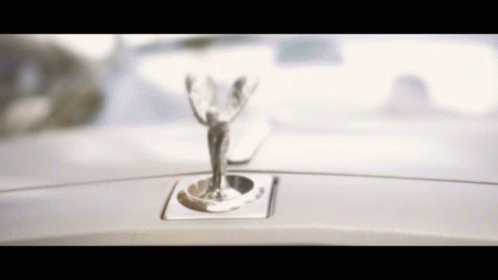 A Close Up Of A Car Emblem That Looks Like A Statue GIF