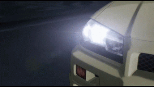 A Close Up Of A Car 'S Headlight With A Glowing Light GIF