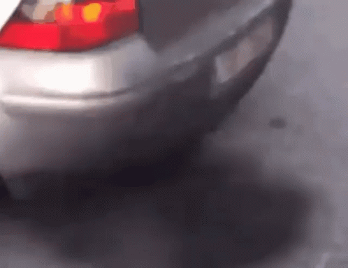 A Close Up Of A Car 'S Tail Light And Exhaust Pipe GIF