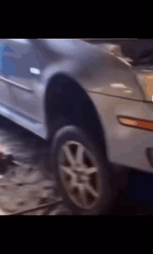 A Close Up Of A Car With A Tire On It GIF