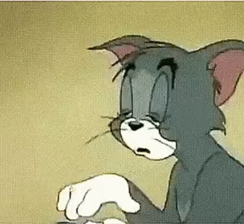 A Close Up Of A Cartoon Cat Holding A Mouse In His Paws . GIF