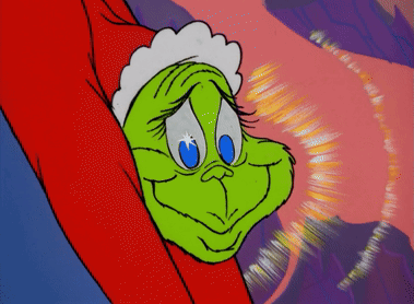 A Close Up Of A Cartoon Character Grinch 'S Face With Blue Eyes GIF