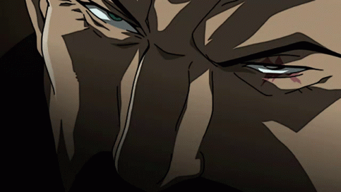A Close Up Of A Cartoon Character 'S Eye With A Red Triangle In The Middle GIF