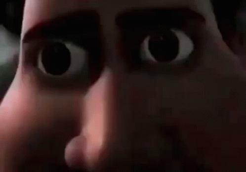 a close up of a cartoon character 's face with big eyes and a mouth open .