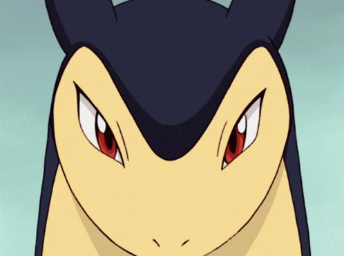 a close up of a cartoon character 's face with red eyes and sharp teeth