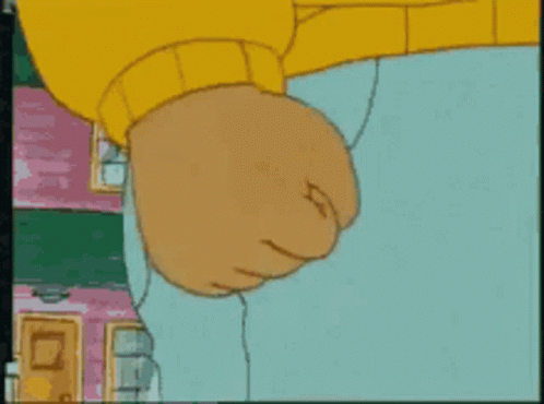A Close Up Of A Cartoon Character 'S Fist With A Pink Building In The Background GIF