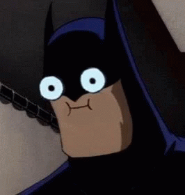A Close Up Of A Cartoon Character Wearing A Batman Mask With Big White Eyes . GIF