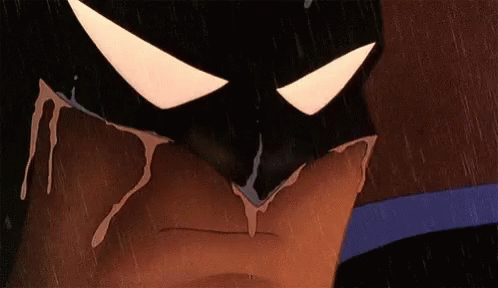 A Close Up Of A Cartoon Character Wearing A Batman Mask With Blood Dripping From It . GIF