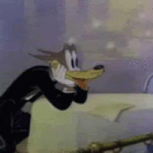 A Close Up Of A Cartoon Character Wearing A Tuxedo And A Hat . GIF