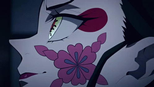 A Close Up Of A Cartoon Character With A Flower On Her Face GIF