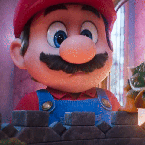 A Close Up Of A Cartoon Character With A Red Hat And Blue Overalls GIF
