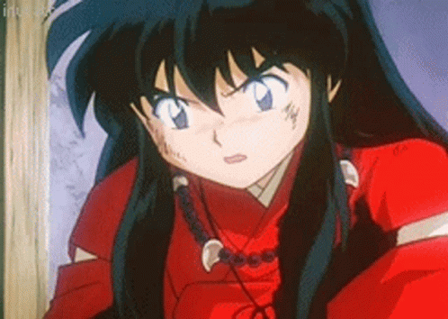 A Close Up Of A Cartoon Character With Long Black Hair Wearing A Red Shirt And A Necklace . GIF
