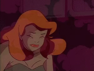 A Close Up Of A Cartoon Character With Red Hair And A Green Dress . GIF
