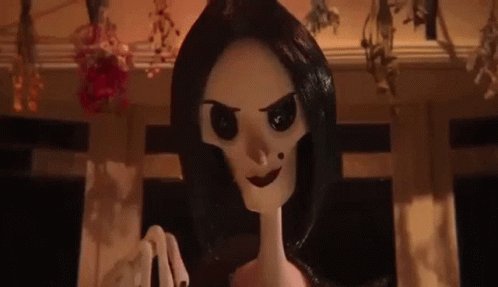 A Close Up Of A Cartoon Doll With Black Hair And A Skeleton Head . GIF