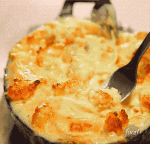 A Close Up Of A Casserole Dish With A Spoon In It And The Words Food Network On The Bottom GIF