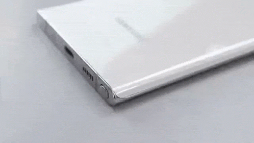 A Close Up Of A Cell Phone With A Pencil Plugged In . GIF