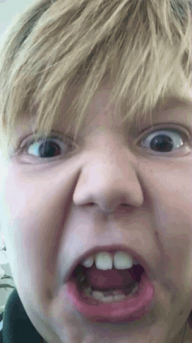 A Close Up Of A Child Making A Funny Face GIF