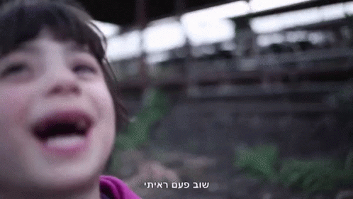 A Close Up Of A Child 'S Face With A Foreign Language Written On The Bottom GIF