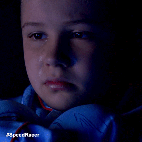 A Close Up Of A Child 'S Face With A Tear Coming Out Of His Eye And The Words #Speedracer On The Bottom GIF