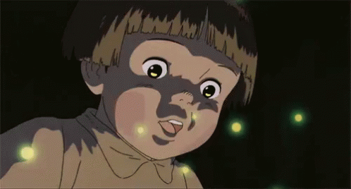 A Close Up Of A Child 'S Face With Fireflies Coming Out Of It 'S Mouth . GIF