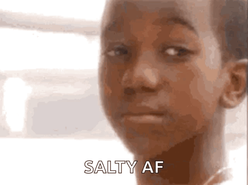 A Close Up Of A Child 'S Face With The Words Salty Af Written On The Bottom GIF