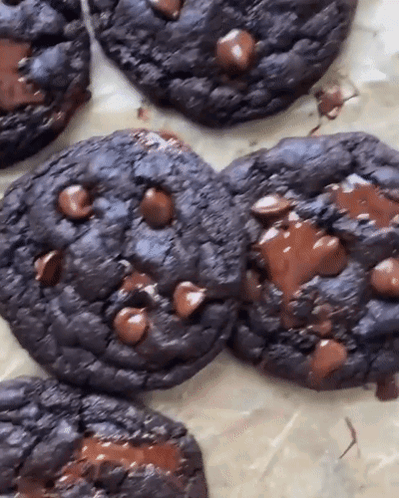 A Close Up Of A Chocolate Chip Cookie On A Table GIF