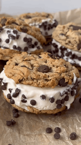 A Close Up Of A Chocolate Chip Cookie Sandwich On A Table GIF