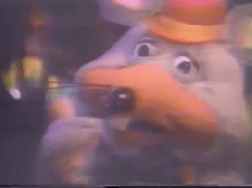 A Close Up Of A Chuck E Cheese Character With A Hat On GIF