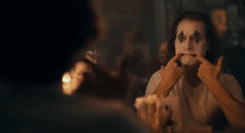 Close Up Clown Making Face With Fingers GIF