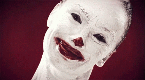 A Close Up Of A Clown 'S Face With Blood On It GIF