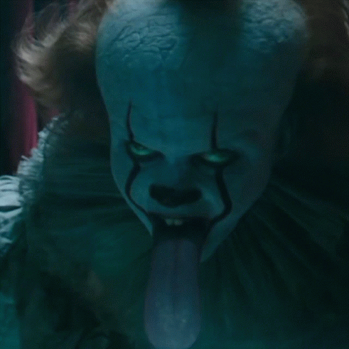 A Close Up Of A Clown 'S Face With His Tongue Sticking Out GIF