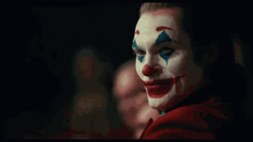 A Close Up Of A Clown With A Red Cape On GIF