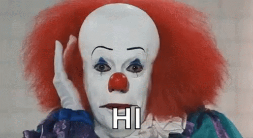 A Close Up Of A Clown With Red Hair And A Red Nose . GIF