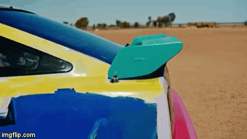 A Close Up Of A Colorful Car With A Spoiler On The Back Of It . GIF