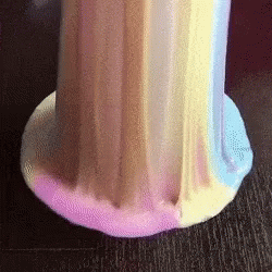 A Close Up Of A Colorful Slime On A Table . GIF