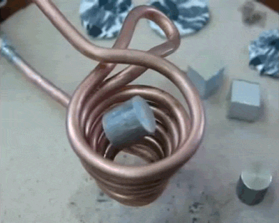 A Close Up Of A Copper Coil With A Piece Of Metal Inside GIF